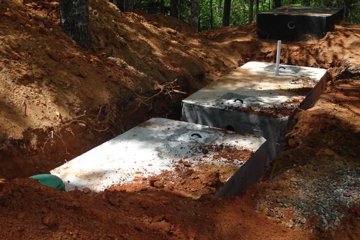 Installing tanks beneath the kitchen garden. Consist of two new 1500 gal septic tanks tied together.