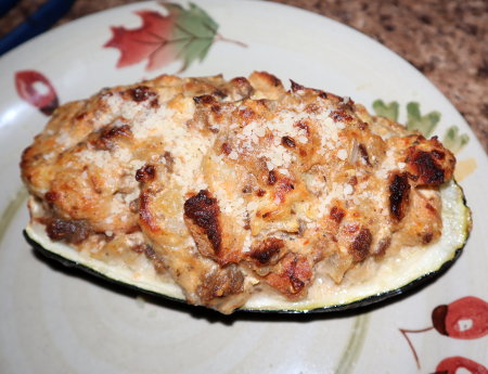 Ricotta stuffed zucchini with mozzarella and sausage and topped with Parmesan cheese.