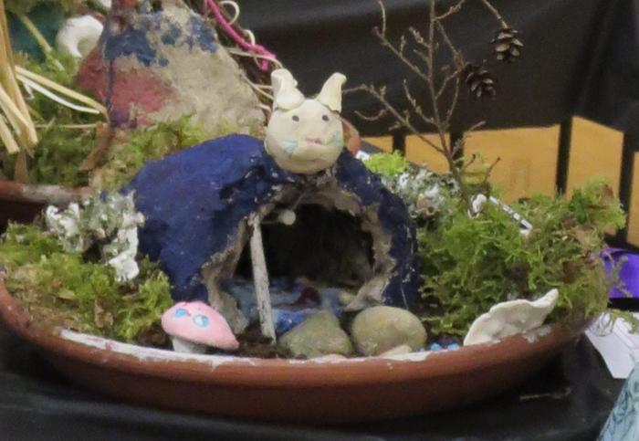 My daughter had already made a wattle and daub house, so she used the materials to make a little hobbity home!