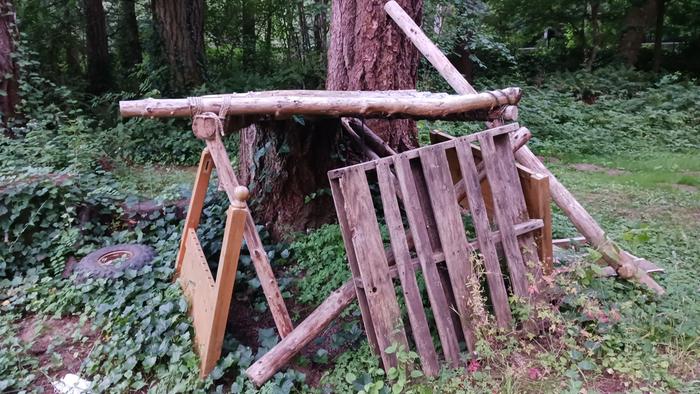 The beams and posts are joined with round tenons. Pegs join the beams to the stump behind