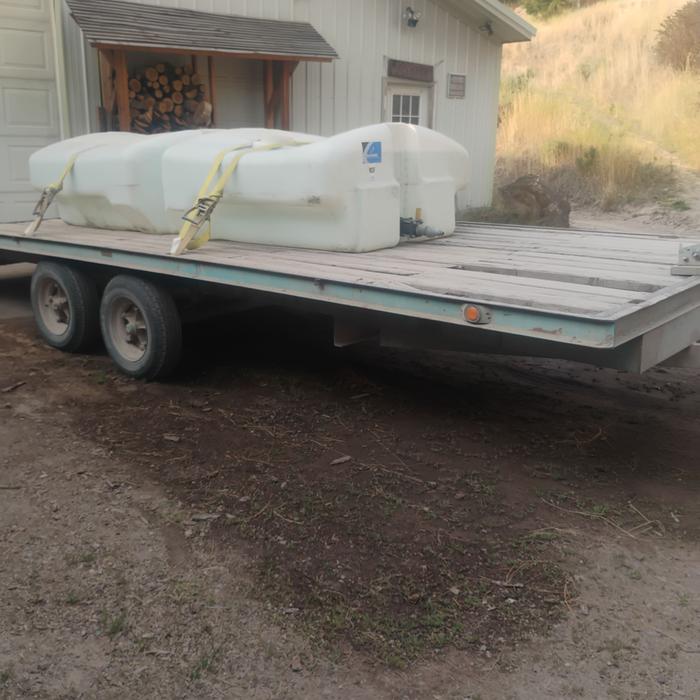 irrigation tanks on a tilt deck trailer