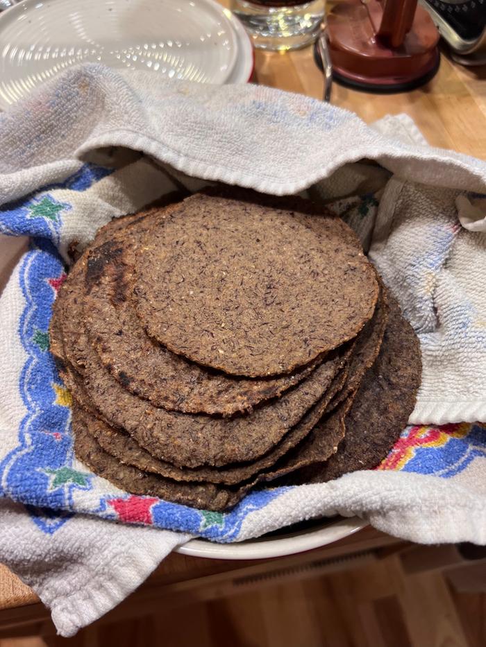 A stack of tortialls. They taste markedly of popcorn. They were good, but made simply amazing chips when fried or baked.