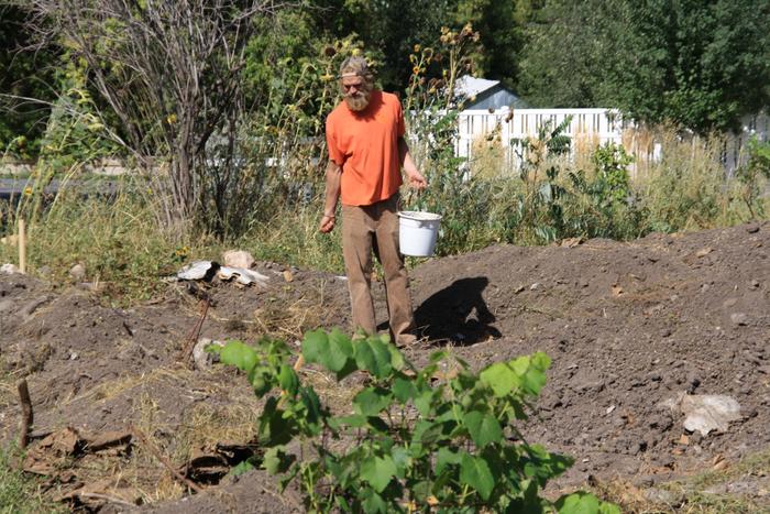 summer intern/apprentice Gabe Grace sewing cover crop