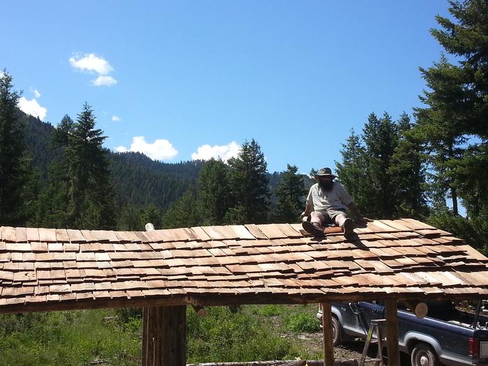 shadowy supervisor safely sitting atop the shingled shit skidder