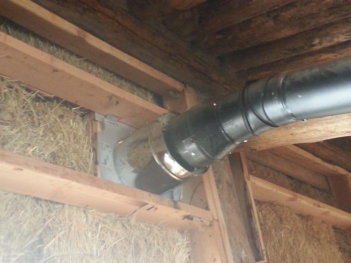 stove exhaust exiting through unfinished strawbale wall, needs to be plugged during second phase of experiment maybe