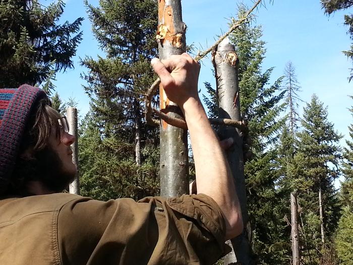 Kai tying posts together with roasted sticks