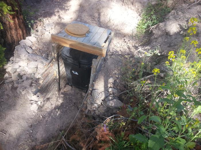 earth-sheltered wheelie bin toilet