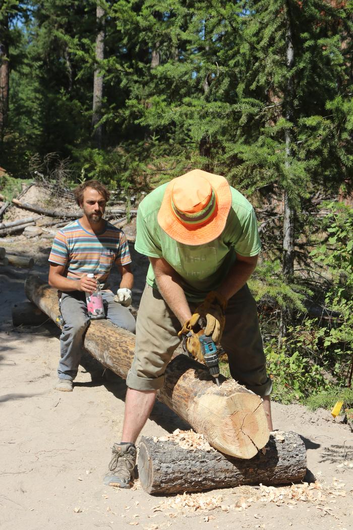 Stephen and Grey drill holes in the skids