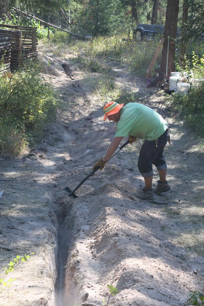 Stephen filling in trench