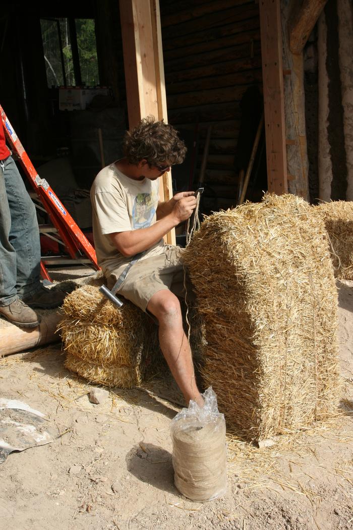 Zach stitching a bale