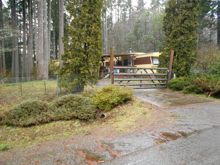 Northwest view of single wide recently sealed and painted