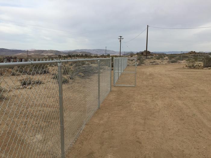 Walk-in gate in chain-link fence in the desert