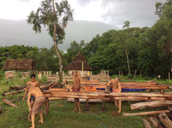 A storm rolls in as the boys lift the frame to the foundation