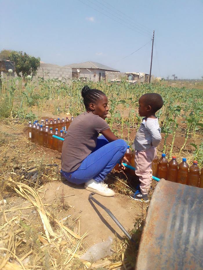 Enock was trying to understand what a raised bed is.