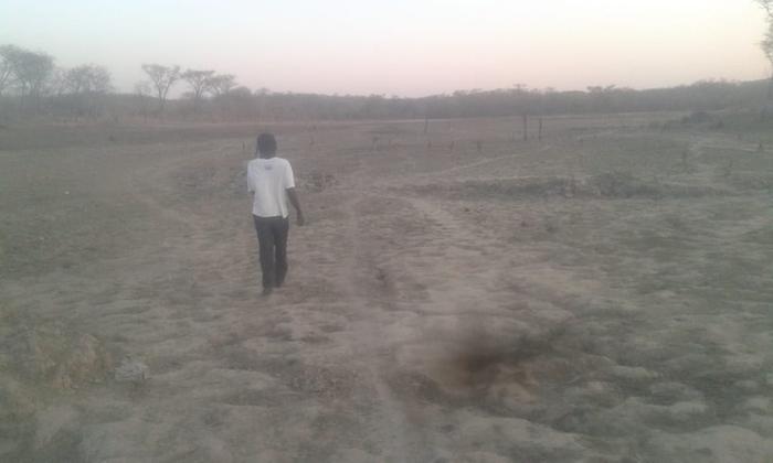 My uncle walking on the base of the dam that he has seen for the first time