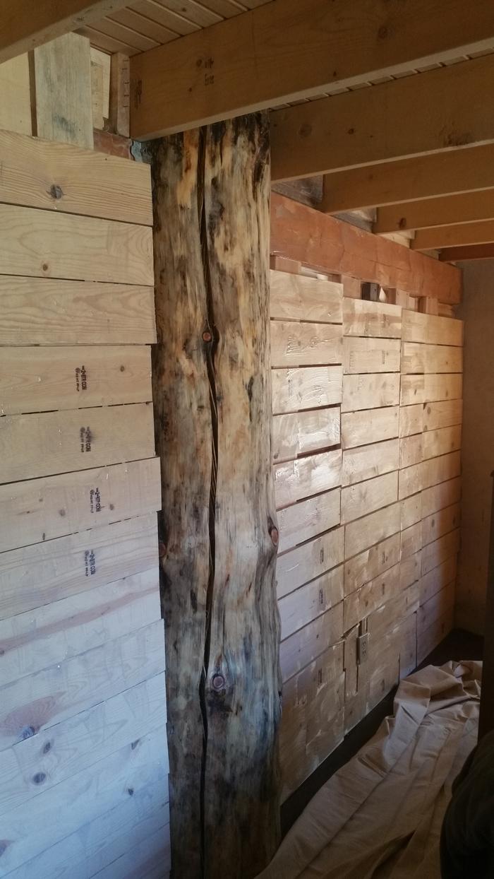 lath bedroom wall being coated with wheat paste, sand, clay texture coat