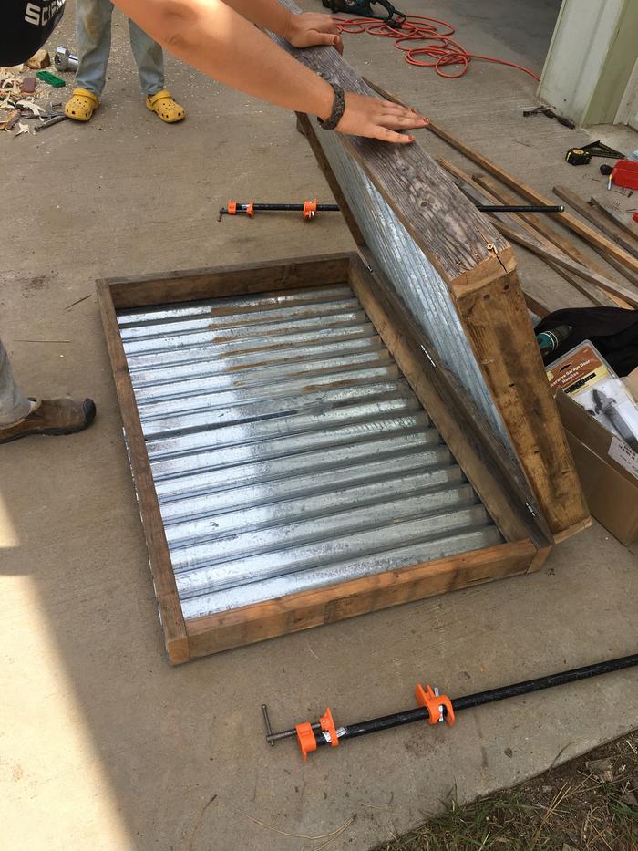 Hinged the two boxes together into a clam and added sheet metal to the bottom one for the trays to sit on and on the bottom of the solar chimney top clam box