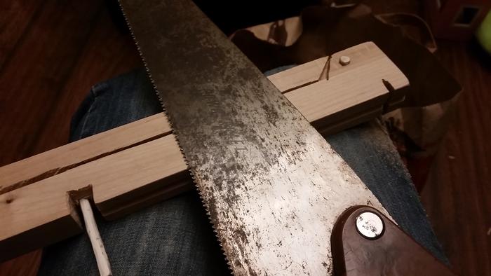 sawing the notch for a crossbow bow