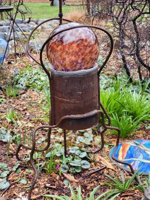 welded yard art with glass ball