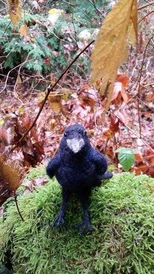 Needle-felted raven in the autumn woods