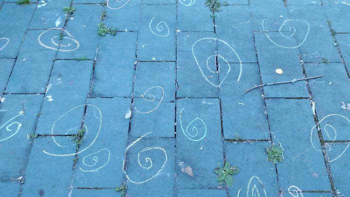 picture of chalk spirals on a cement patio