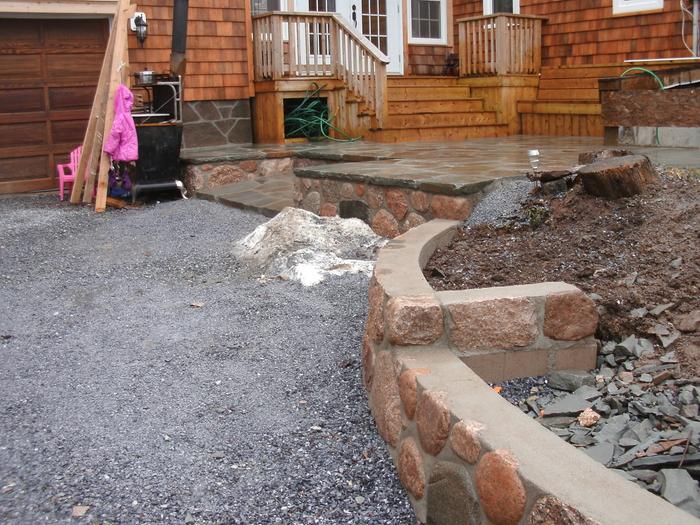 Low retaining wall in concrete and steel reinforced granite.