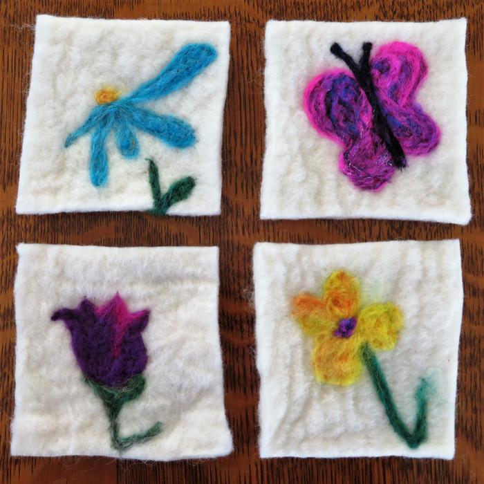 needle felted coasters flower designs on white background wool