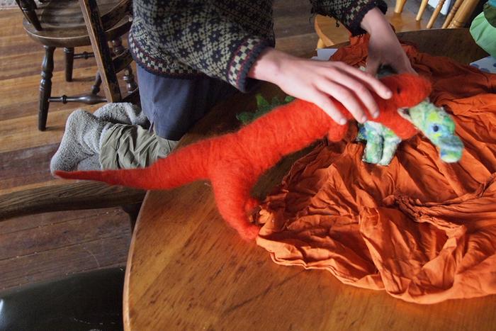 child playing with needle felted dragons natural wool non-toxic toys