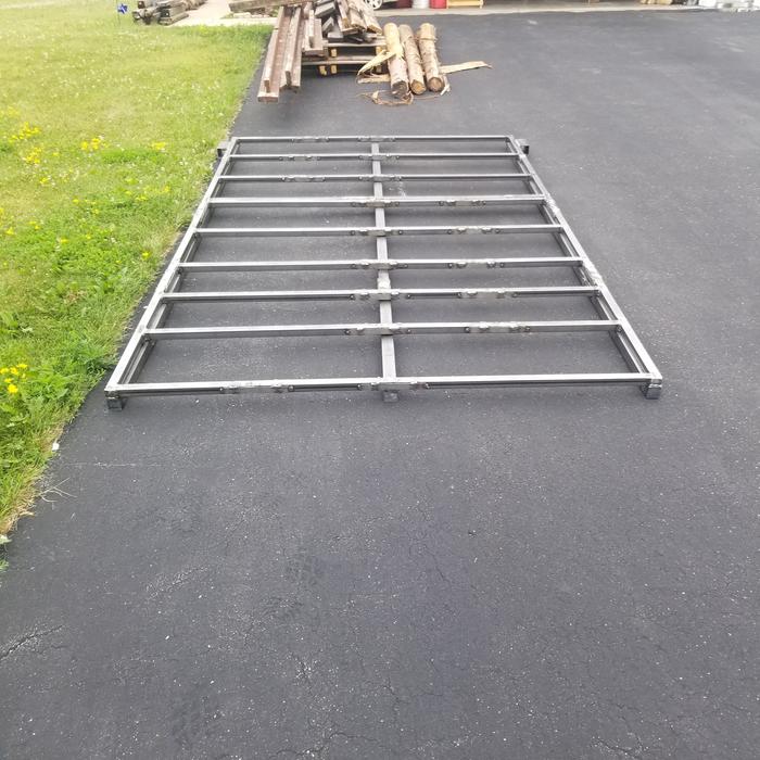 welded frame with pile random pallet/shed wood in driveway 