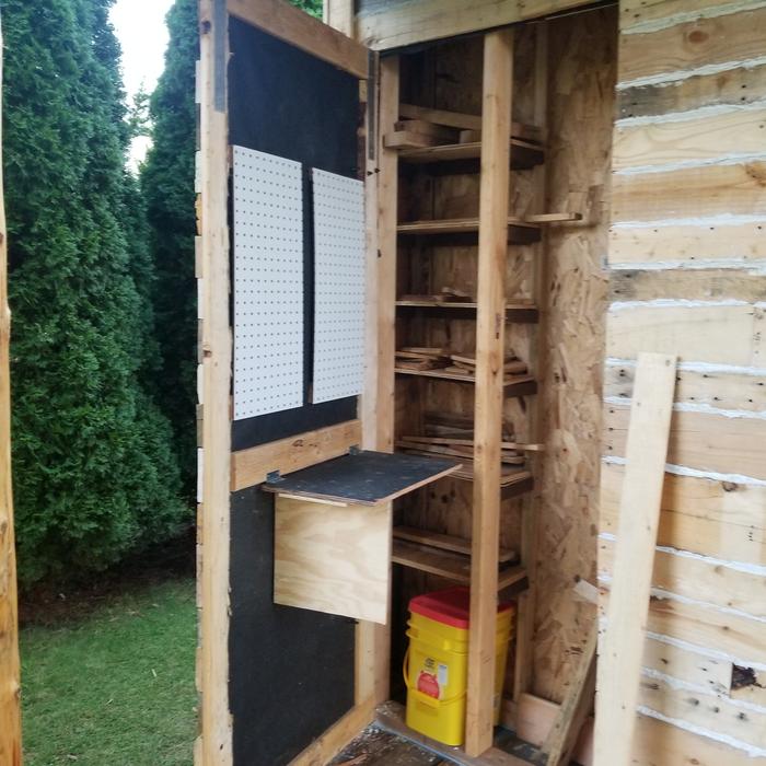 peg board and fold down table on closet door