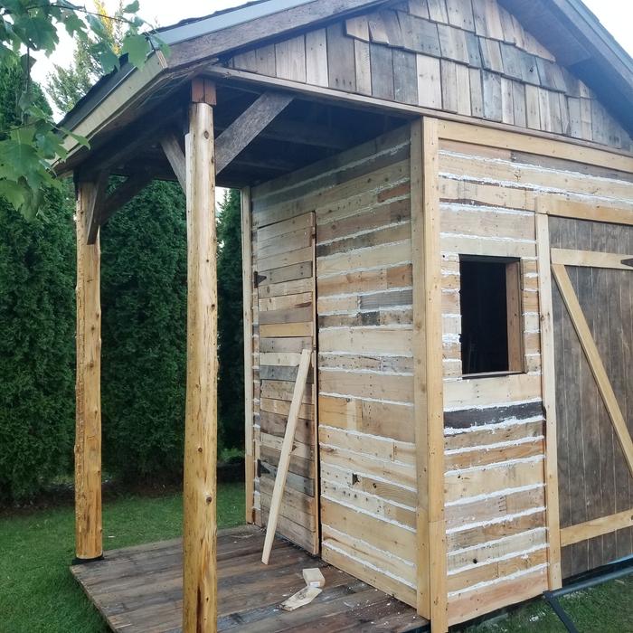 mortared walls, gables done, roof done, closet door being held shut with a board.