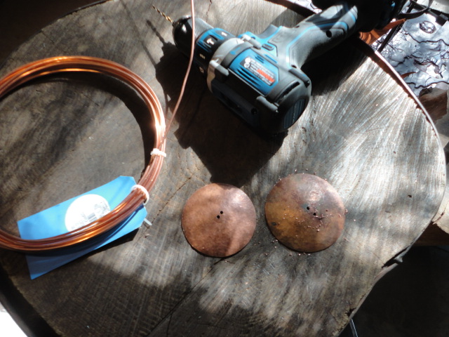 The two copper disks with holes drilled in and my spool of thick gauge copper wire.