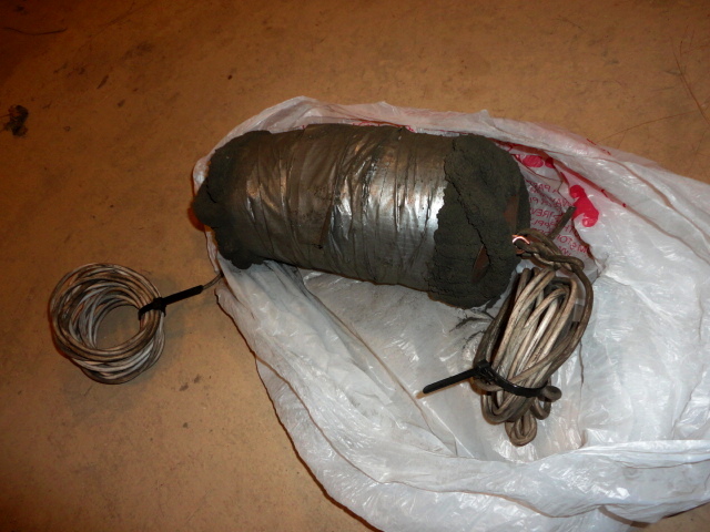 A photo showing the tool after use. You can see how I had to use more duct tape to compress it down more to better fit the pipe. It's much dirtier now, thus the bag to store it.