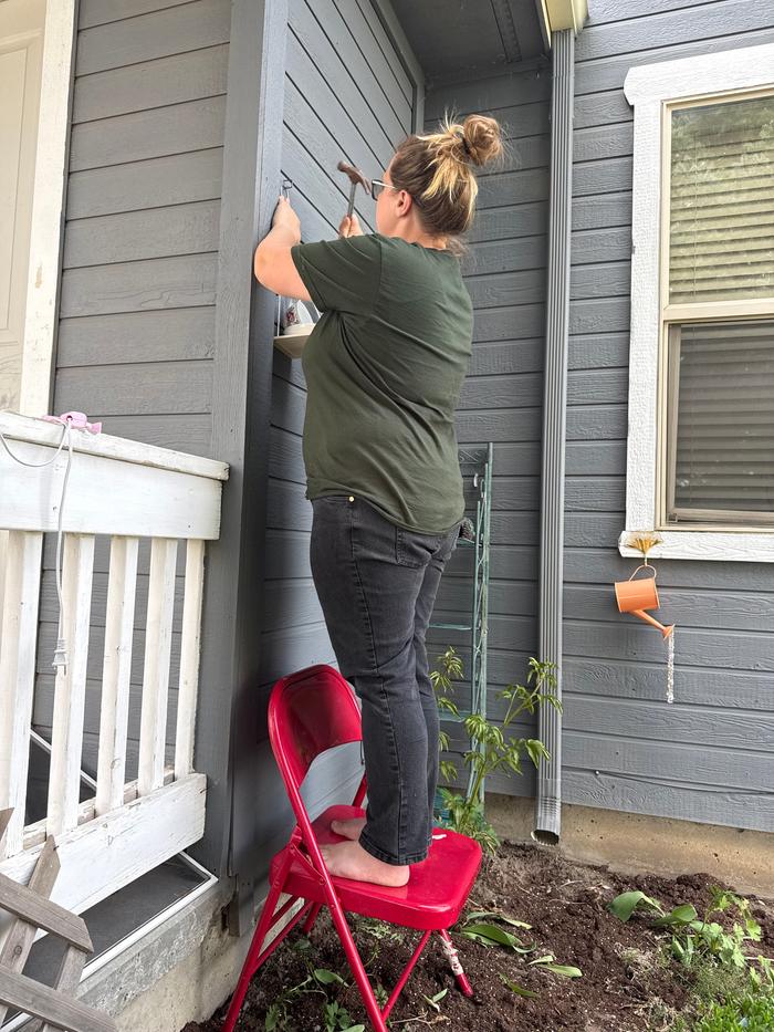 Hanging the birdfeeder in the flower garden