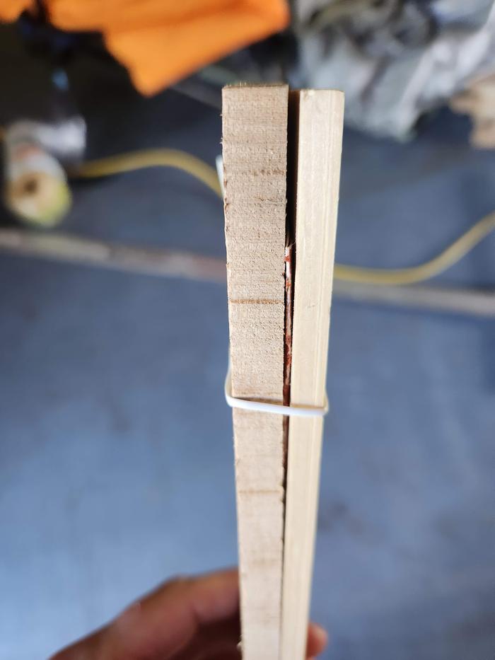 worn out sandpaper used with tie to hold yardstick to stake, but maintain adjustability