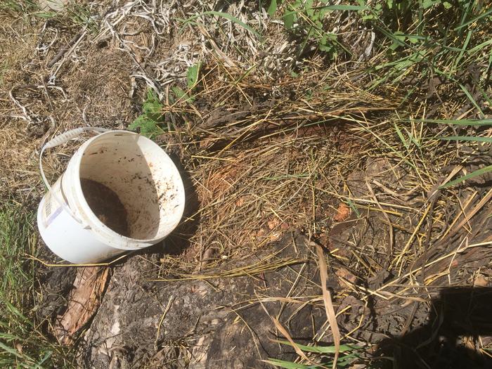 empty bucket and covered hole