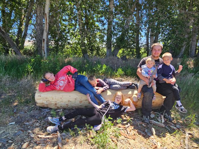 Peeled! All my kids pose on the log for this victory. Do you know how many tiny poky nubs elm trees have!? for the pic